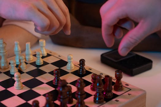 Close-up of hands playing a chess game, capturing strategic moves and intense focus.